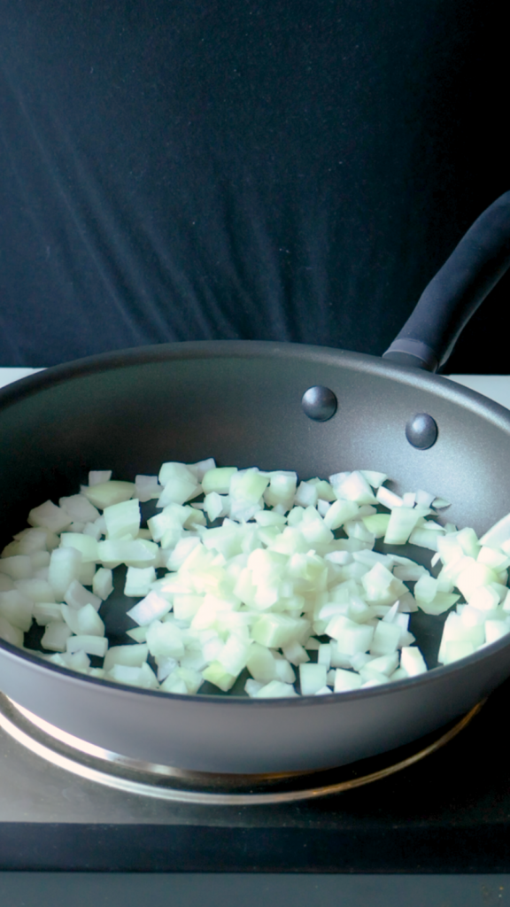 Heat oil in your Meyer frying pan and stir in chopped onion and jalapeño, cooking until onions are golden brown